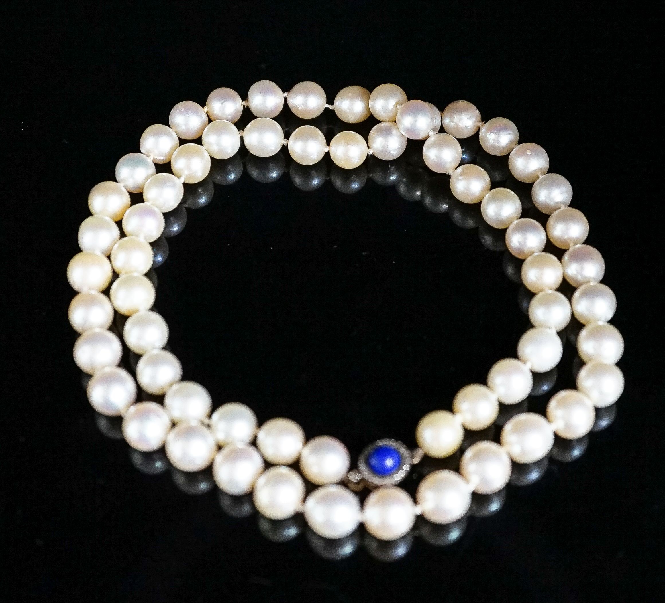 A single strand cultured pearl necklace, with yellow metal, lapis lazuli and diamond set clasp, 63cm, gross weight 67.1 grams.